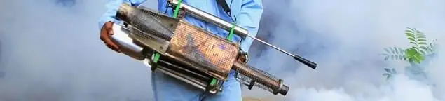Fumigation technician using a fogger for deep pest treatment in Rockford, IL